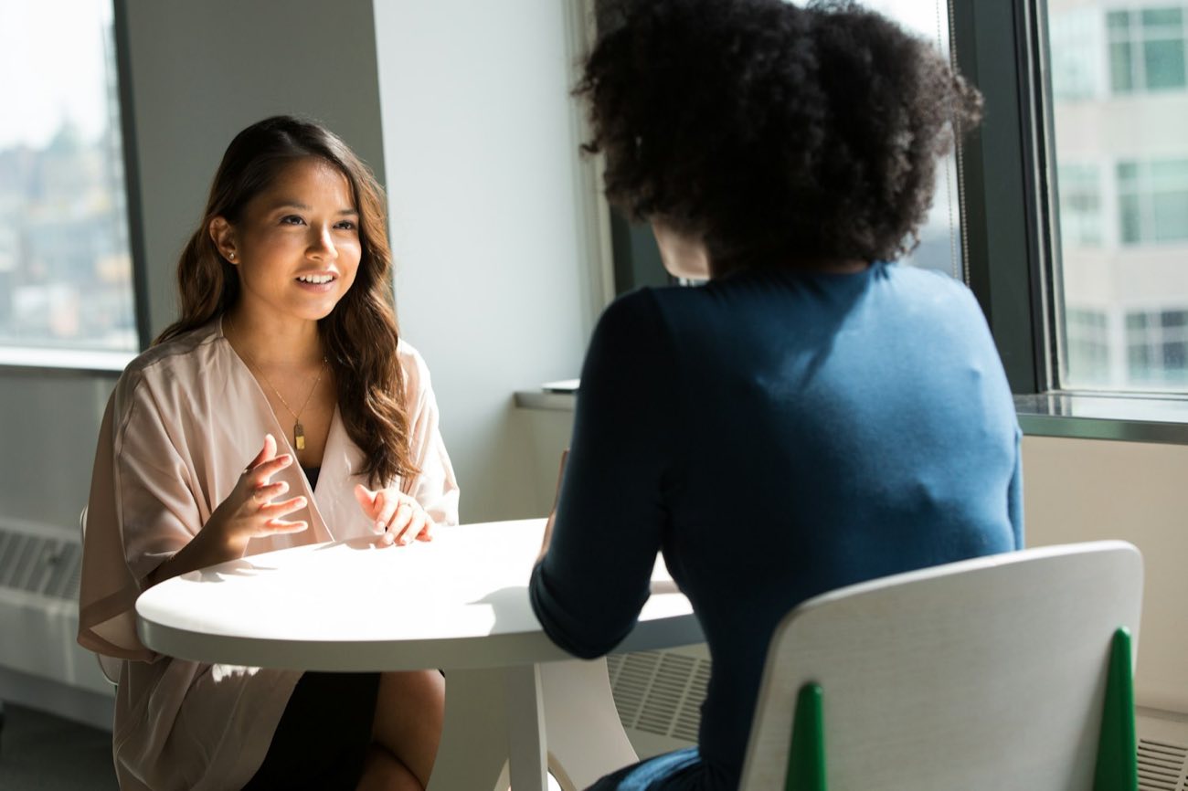 Two women talking across a table