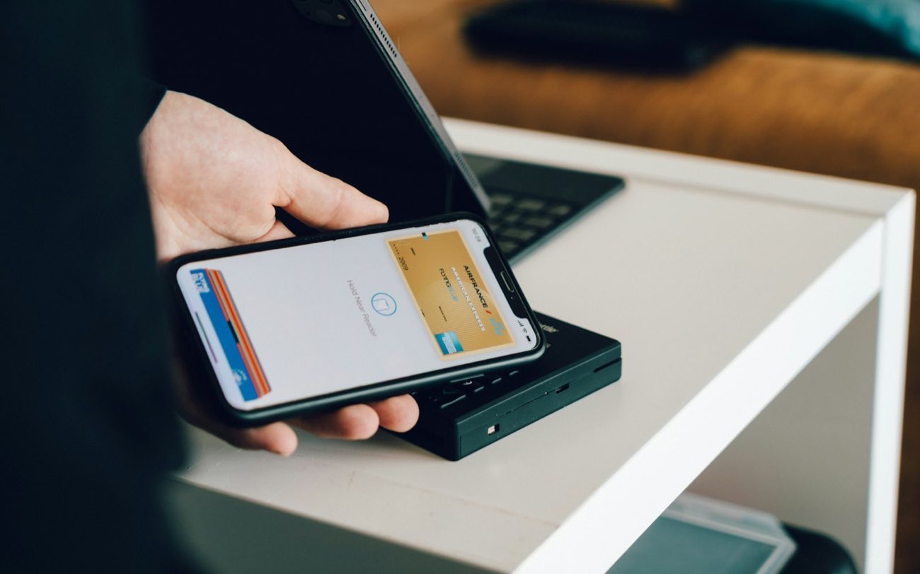 Phone and card held over a table
