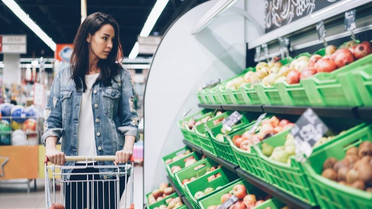 Woman with a cart in the produce aisle