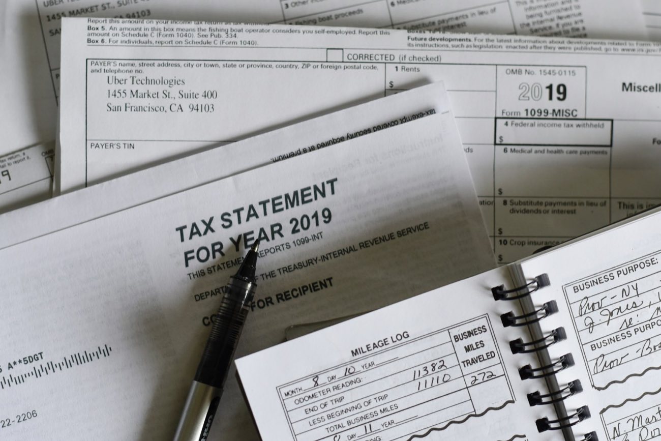 Tax statement beside a notebook