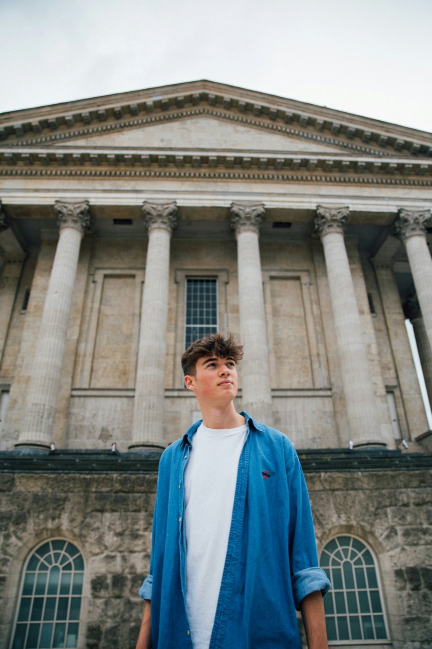 Student outside a columned building
