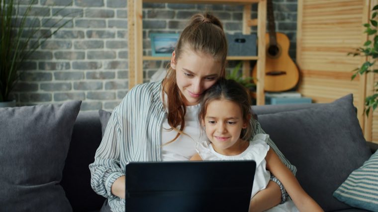 A mother and child at a laptop
